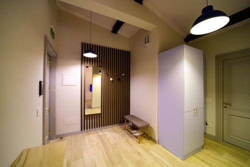 a room with a hallway with a bench and a mirror at First Apartments in Focşani