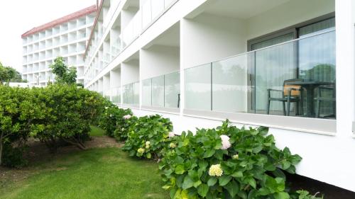 an office building with plants on the side of it at Grand Hotel Ontur Cesme in Cesme