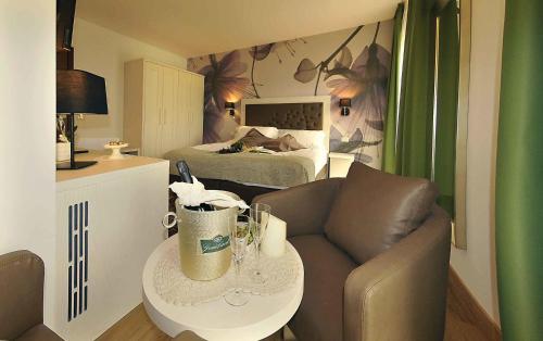 a living room with a couch and a bed at Hotel Florida in Levico Terme