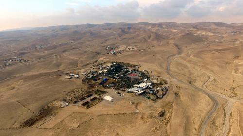 an aerial view of a village in the middle of a desert at Kfar Hanokdim - Desert Guest Rooms in Arad
