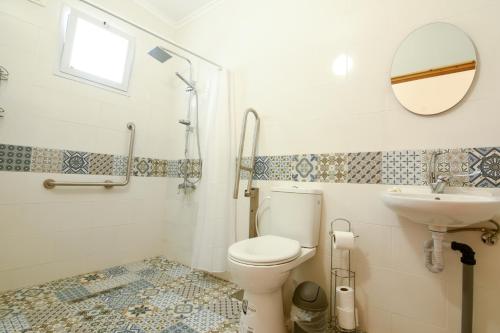 a bathroom with a toilet and a sink at Kfar Hanokdim - Desert Guest Rooms in Arad