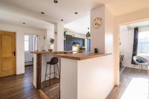 Il comprend une cuisine avec des murs blancs, du parquet et un comptoir. dans l'établissement La 