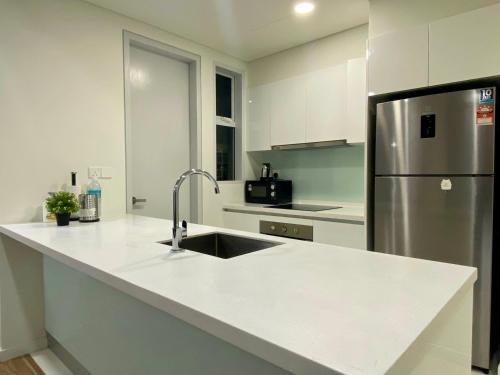a kitchen with a sink and a refrigerator at KL East The Ridge in Kuala Lumpur
