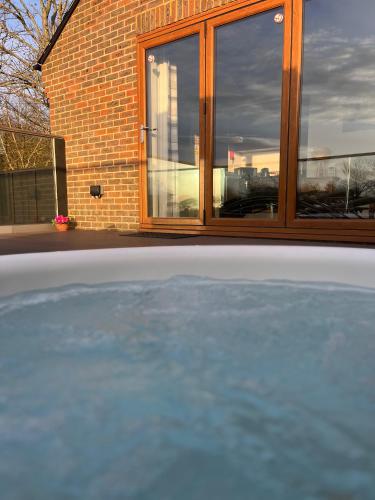a pool of water in front of a building at Rife Lodges in Arundel