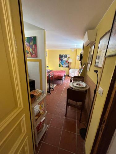 a hallway with a living room with a table and a couch at La Masa in Èze