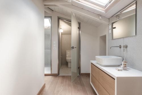 ein Bad mit einem Waschbecken und einem Spiegel in der Unterkunft Viatzo Villas in Laganas