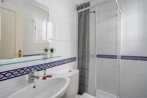a bathroom with a toilet and a sink and a shower at Hillside terrace in La Cala de Mijas Ref 143 in La Cala de Mijas