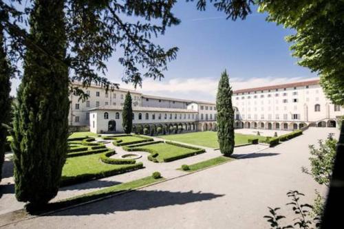 a large white building with trees and a courtyard at Studio Moderne, Terrasse et Parking in Romans-sur-Isère