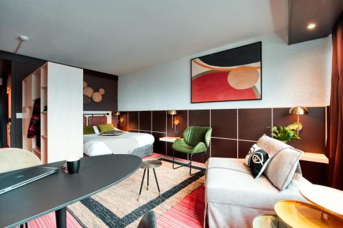 a hotel room with two beds and a table at COWOOL GRENOBLE in Grenoble
