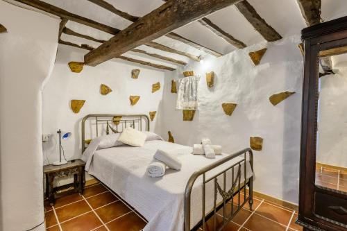 a bedroom with a bed in a room with white walls at Villa Can Sarrio in Sant Carles de Peralta