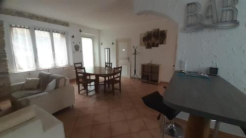 a living room with a table and a dining room at Appartemment situé a lacaune les bains in Lacaune