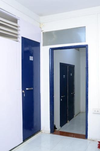 an empty room with two doors and a mirror at Hotel Sairam Lodge in Nashik
