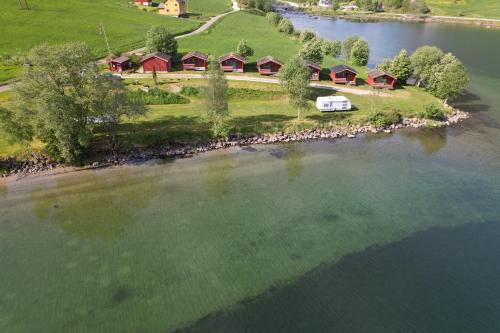 an aerial view of a house on an island in the water at Løken Camping - trivelig og idyllisk ved vannet in Olden