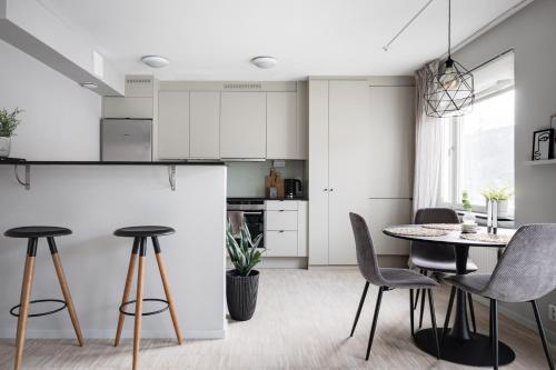a kitchen and dining room with a table and chairs at Peaceful Scandinavian Studio - 19mins from City Centre in Stockholm