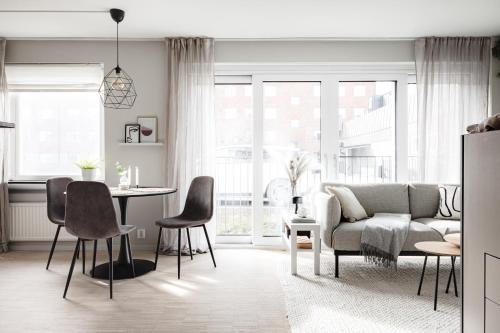 a living room with a couch and a table at Peaceful Scandinavian Studio - 19mins from City Centre in Stockholm