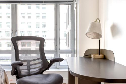 a dining room with a table and a chair at Back Bay Studio w WD Gym Roof nr Copley Sq BOS-752 in Boston