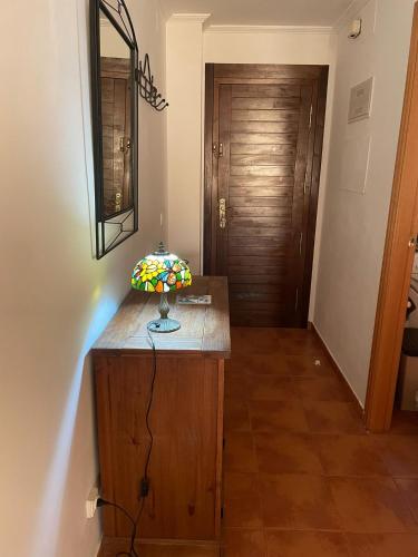 a room with a wooden counter with a mirror and a door at Casa Valero in Rubielos de Mora