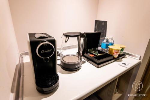 a counter with a coffee maker and a blender on it at The Aru Hotel at Aru Suites in Kota Kinabalu