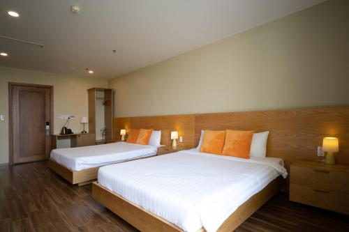 Postel nebo postele na pokoji v ubytování Sline Hotel and Apartment