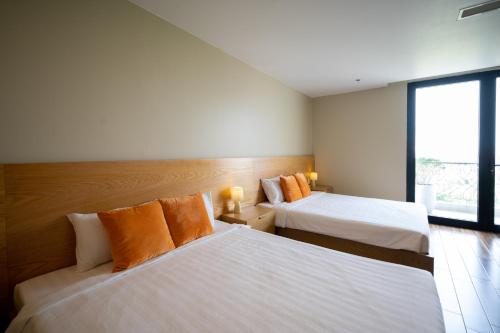 Postel nebo postele na pokoji v ubytování Sline Hotel and Apartment