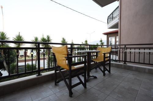 two yellow chairs and a table on a balcony at Villa Le Chocolate in Vrasná