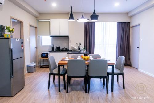 a kitchen and dining room with a table and chairs at The Aru Hotel at Aru Suites in Kota Kinabalu