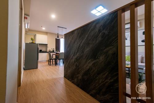 a living room with a large black marble wall at The Aru Hotel at Aru Suites in Kota Kinabalu