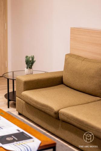 a living room with a couch and a table at The Aru Hotel at Aru Suites in Kota Kinabalu