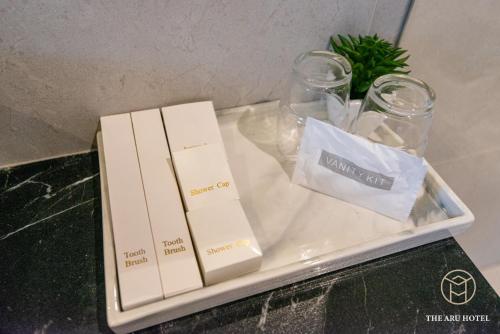 a table with two boxes and glasses on it at The Aru Hotel at Aru Suites in Kota Kinabalu