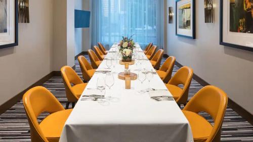 a long table in a room with yellow chairs at Hyatt Regency Bloomington - Minneapolis in Bloomington