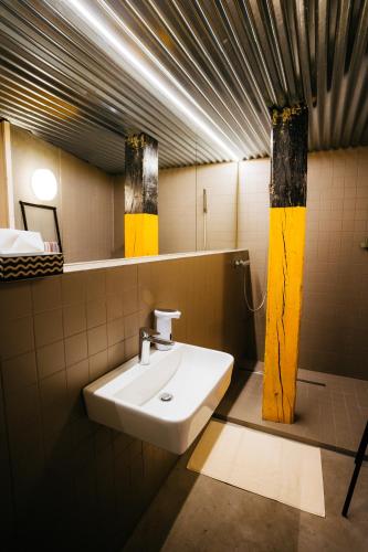 a bathroom with a sink and a mirror at Smaltovňa Lofty in Lučenec