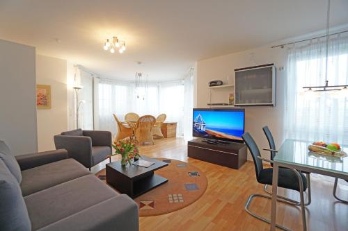 TV a/nebo společenská místnost v ubytování Dünenresidenz mit Meerblick