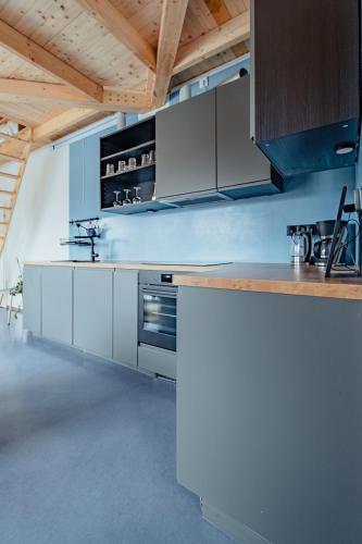 a kitchen with white appliances and wooden ceilings at Ferienwohnungen Fehmarn mit Parkplatz in Petersdorf in Fehmarn