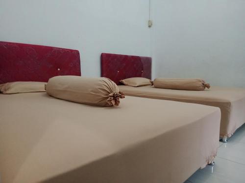 Ένα ή περισσότερα κρεβάτια σε δωμάτιο στο Sipakatau Homestay Bira