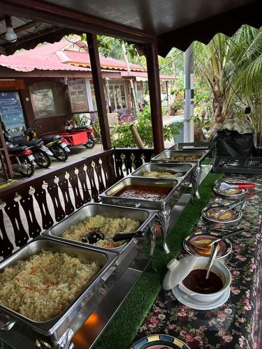 a buffet line with many different types of food at Johans Chalet in Tioman Island