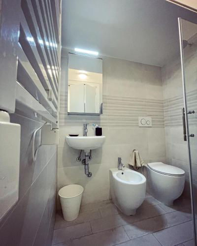 a bathroom with a sink and a toilet and a mirror at 50 Papiniano apartment in Milan