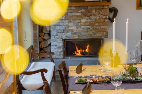 a dining room with a table and a fireplace at Hiša Ojstrica in Solčava