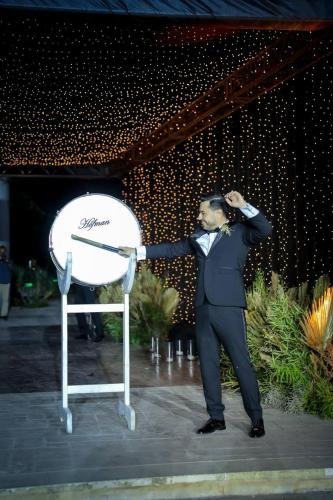 a man in a suit standing next to a chair at Layali Al Shams Hotel in ‘Anjar