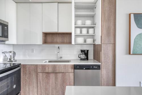 a kitchen with white cabinets and a sink at Miramar 2BR w Gym Pool WD nr WF MIA-70 in Miramar