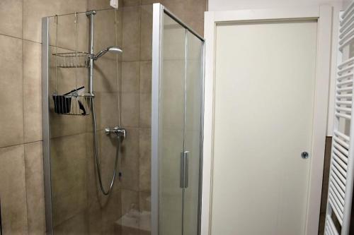 a shower with a glass door in a bathroom at Villetta Pima in Garda
