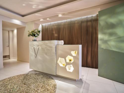 a lobby with a refrigerator with papers on it at Le Meurice – Dorchester Collection in Paris