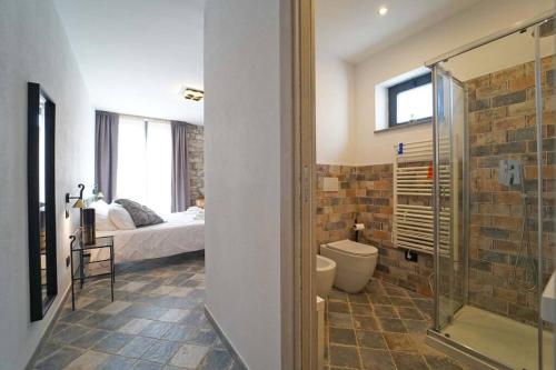 a bathroom with a shower and a bedroom with a bed at Villa Viola 12 pax family retreat pool near 5Terre in Aulla