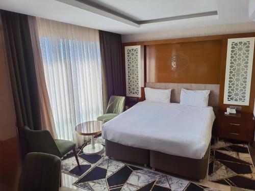 a hotel room with a bed and a table and chairs at Grand Star Hotel Premium in Istanbul