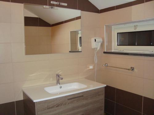 a bathroom with a sink and a mirror at Holiday Affittacamere in Corigliano Calabro
