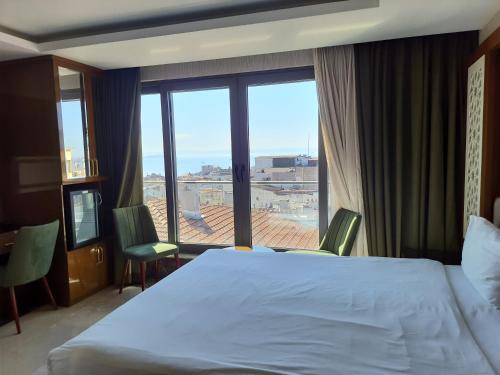 a bedroom with a large bed and a large window at Grand Star Hotel Premium in Istanbul