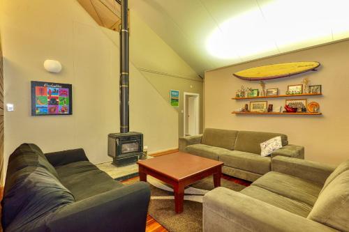 a living room with a couch and a stove at THE BARN in Mahia