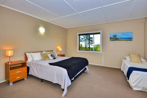 a bedroom with two beds and a window at THE BARN in Mahia
