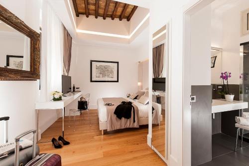 a white bedroom with a bed and a desk at Argentina Residenza Style Hotel in Rome