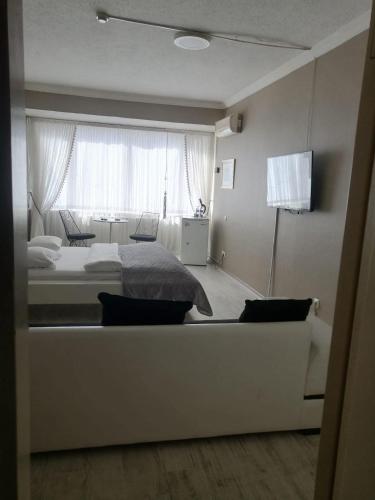 a bedroom with a bed and a large window at Masal Otel in Kocaeli