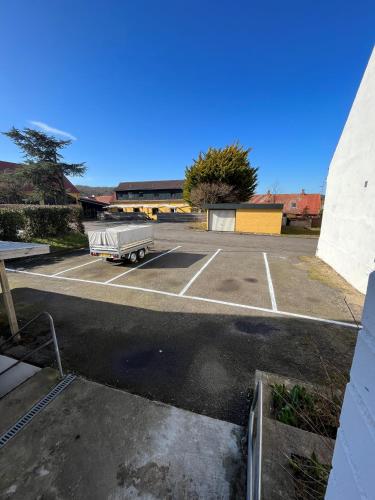 an empty parking lot with a truck in it at Danhostel Sandvig in Sandvig